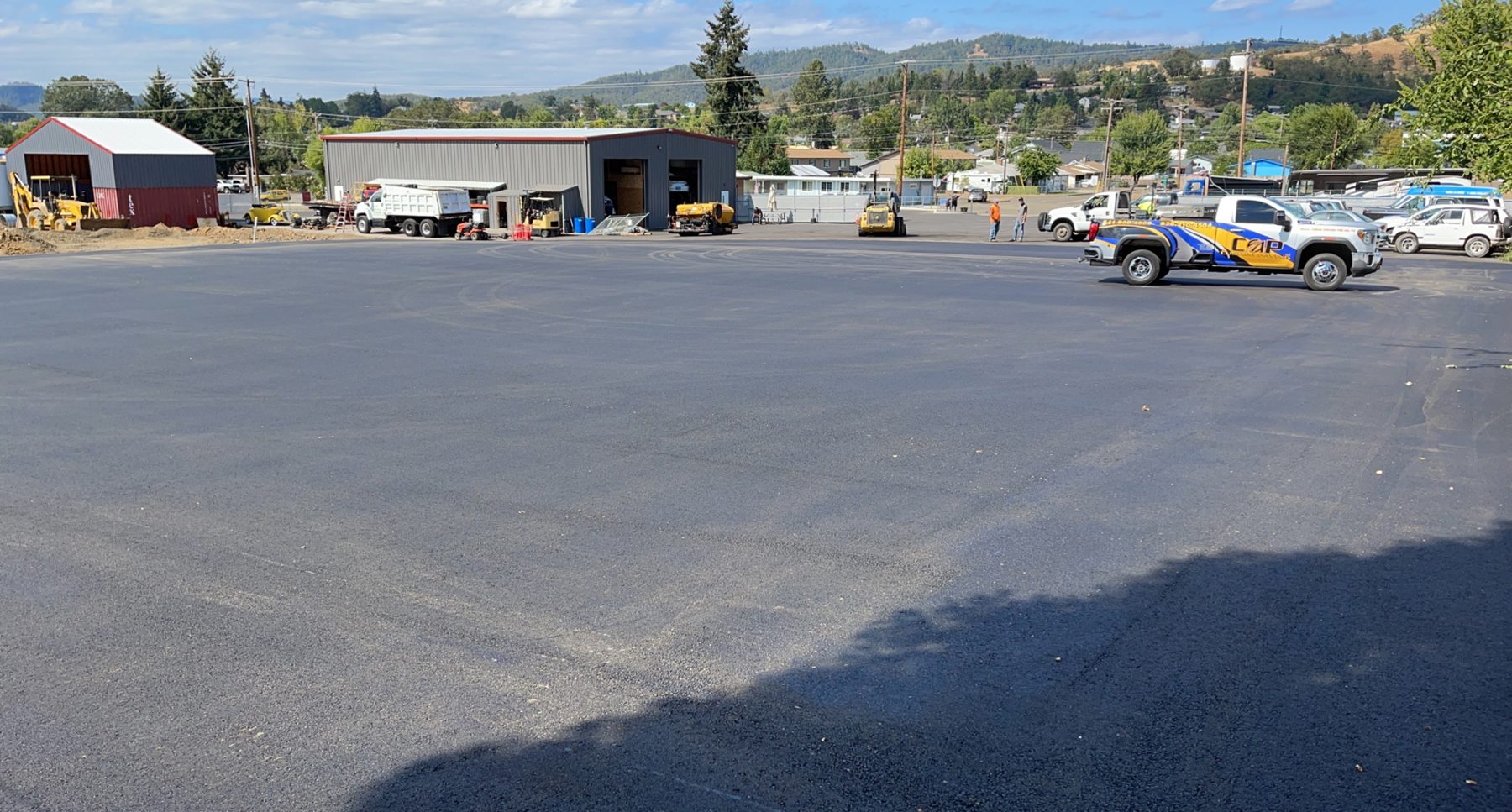 A large asphalt parking and vehicle area.