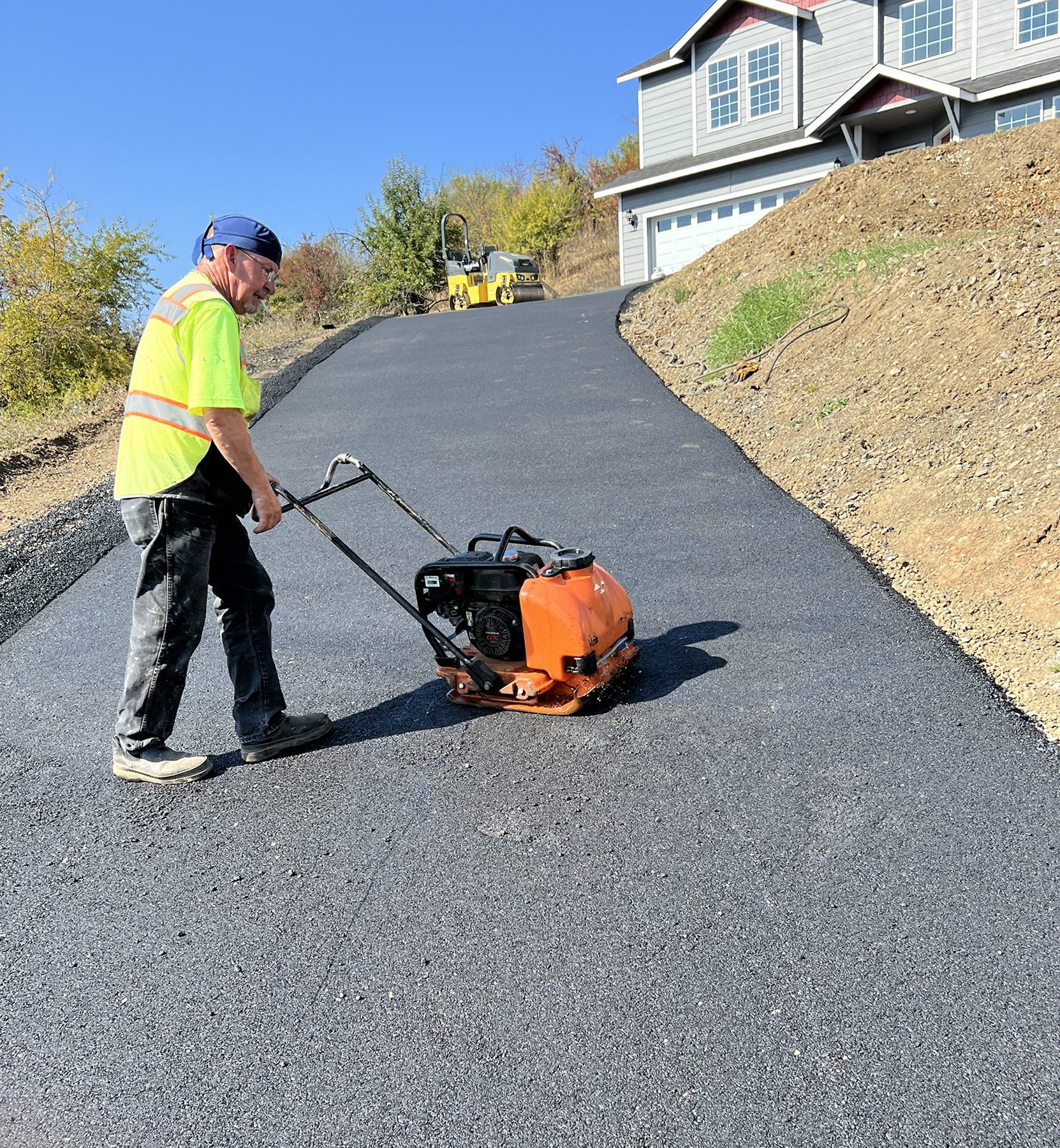 Paving equipment at work on a driveway.